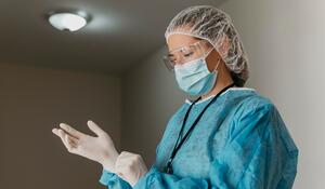 doctor-putting-surgical-gloves